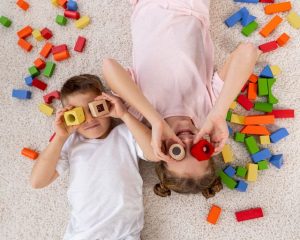 top-view-non-binary-kids-playing-with-colorful-game-Αντιγραφή